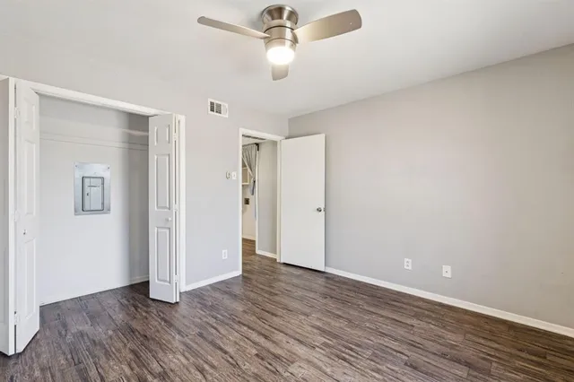 a view of an empty room with wooden floor