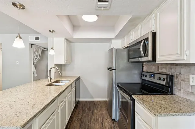 a kitchen with stainless steel appliances granite countertop a sink stove and refrigerator
