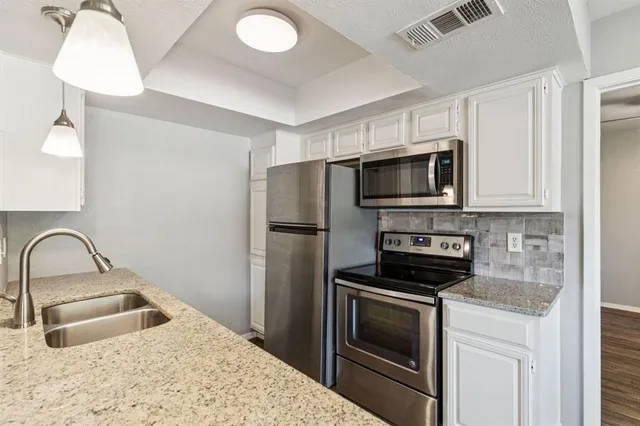a kitchen with a sink stove and microwave