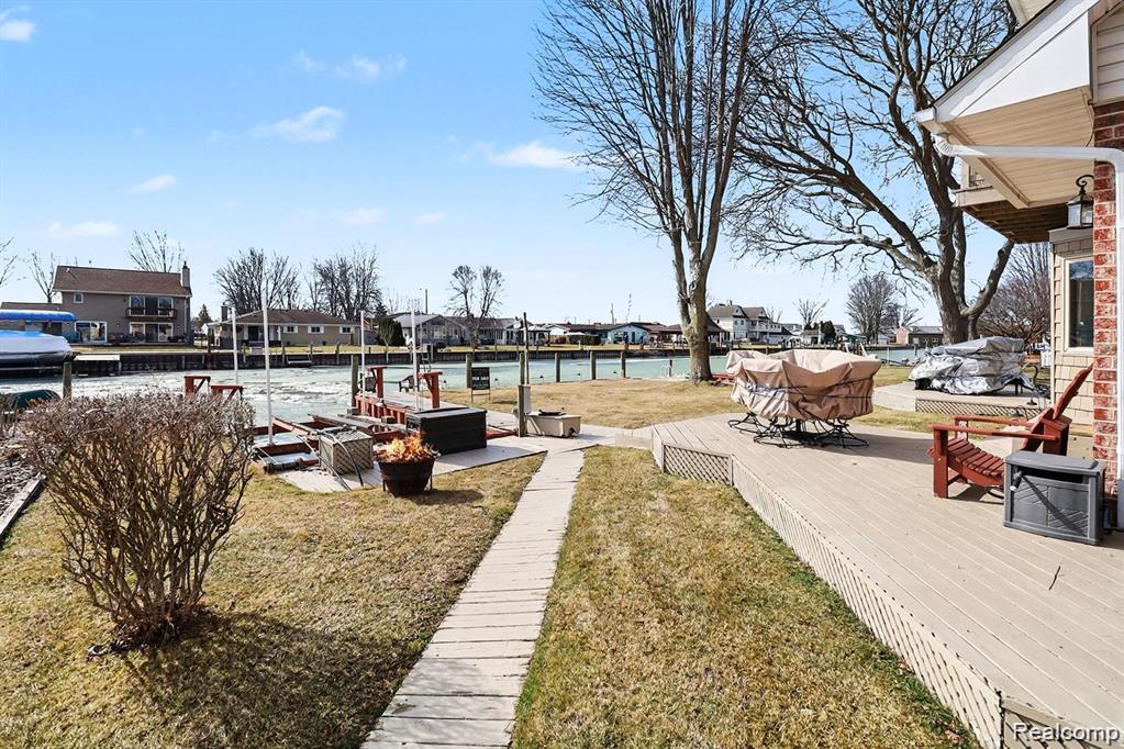 7277 Cardinal Road Algonac, MI 48001 - Photo 12 of 36 View of grassy yard with a deck with water view and a residential view