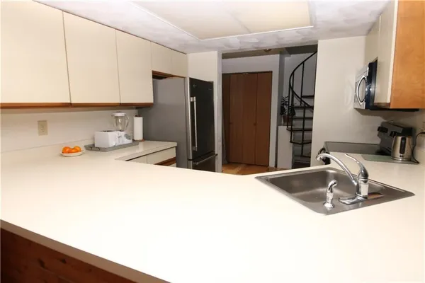 a kitchen with a sink and a refrigerator