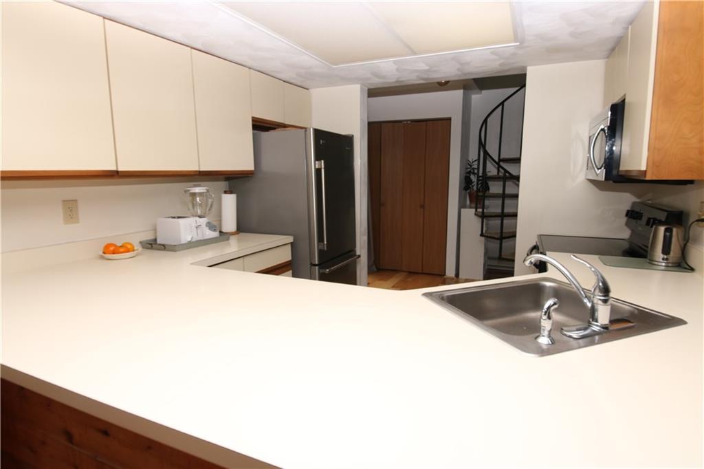 2713 Powder Ridge Road Hidden Valley, PA 15502 - Photo 11 of 30 a kitchen with a sink and a refrigerator