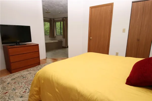 a bedroom with a bed and lamp