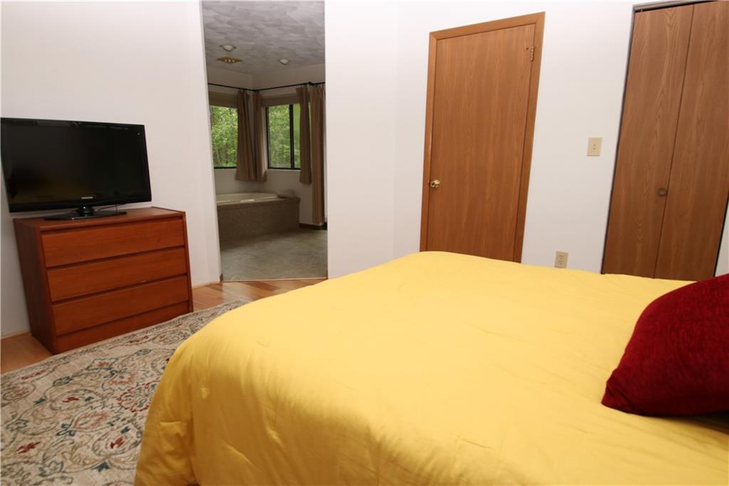 2713 Powder Ridge Road Hidden Valley, PA 15502 - Photo 14 of 30 a bedroom with a bed and a flat screen tv