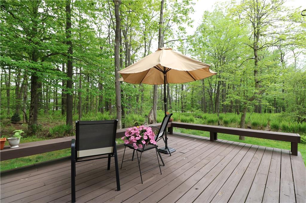 2713 Powder Ridge Road Hidden Valley, PA 15502 - Photo 23 of 30 a view of a deck with furniture and barbeque grill with wooden floor and fence
