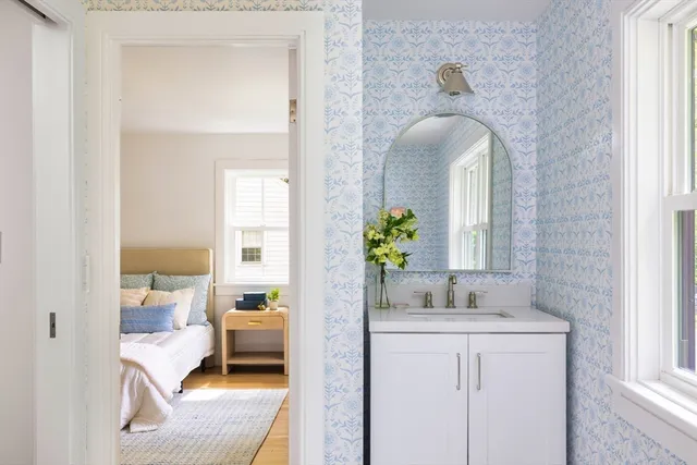 a en suite bathroom with a granite countertop tub and a mirror