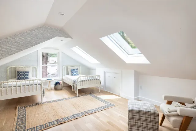 a bedroom with furniture and a window
