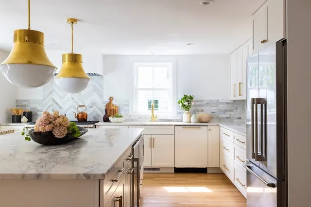a kitchen with a sink a stove and chairs