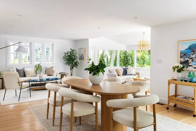 a dining room with furniture window and wooden floor