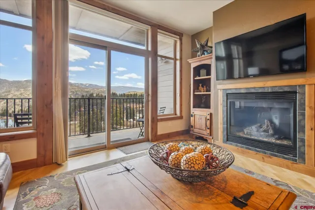 a living room with fireplace furniture and a flat screen tv