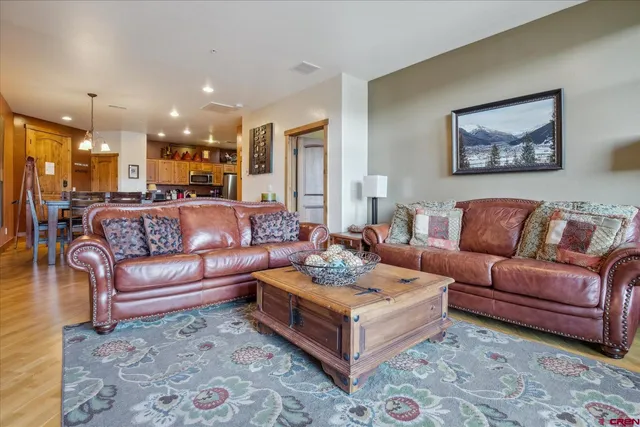 a living room with furniture ceiling fan and a rug