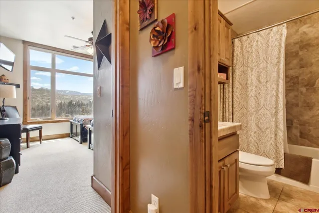 a bathroom with a toilet and a shower