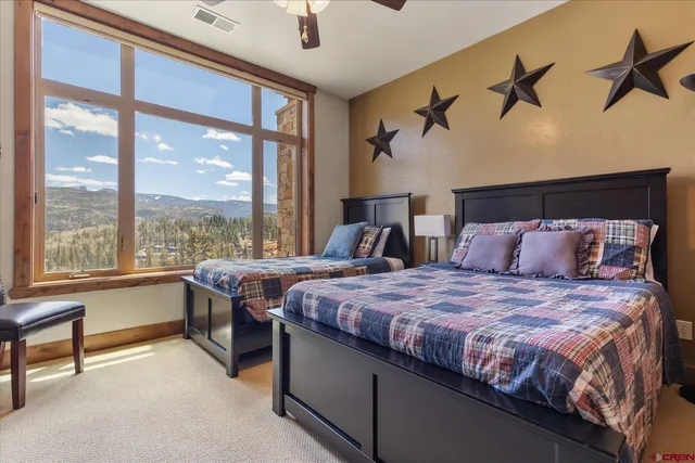 a bedroom with a large bed and a balcony view