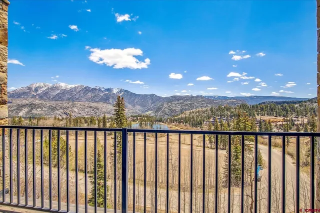 a view of a city with large trees in front of it