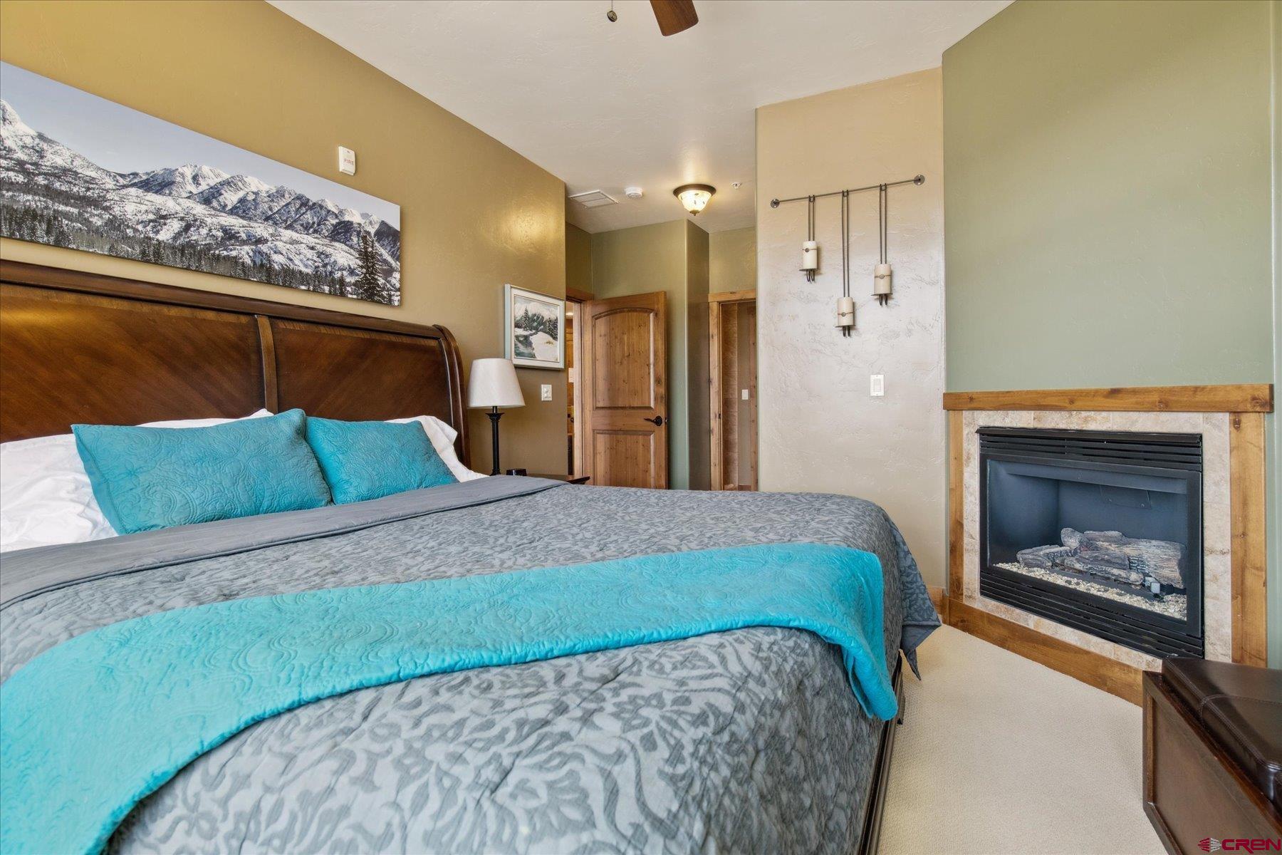 545 Skier Place, Unit 104 Durango, CO 81301 - Photo 34 of 45 a bedroom with a bed and a fireplace