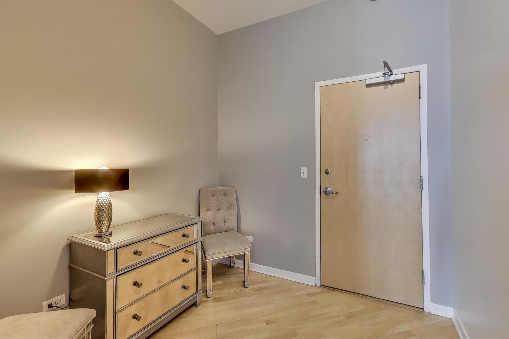 1600 South Indiana Avenue, Unit 1602 Chicago, IL 60616 - Photo 6 of 26 a room with a bed and cabinets