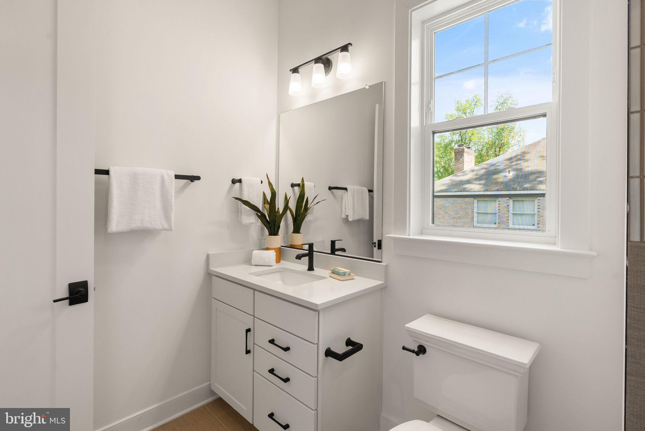 11800 Valley Road Fairfax, VA 22033 - Photo 24 of 76 a bathroom with a sink vanity granite toilet and a mirror
