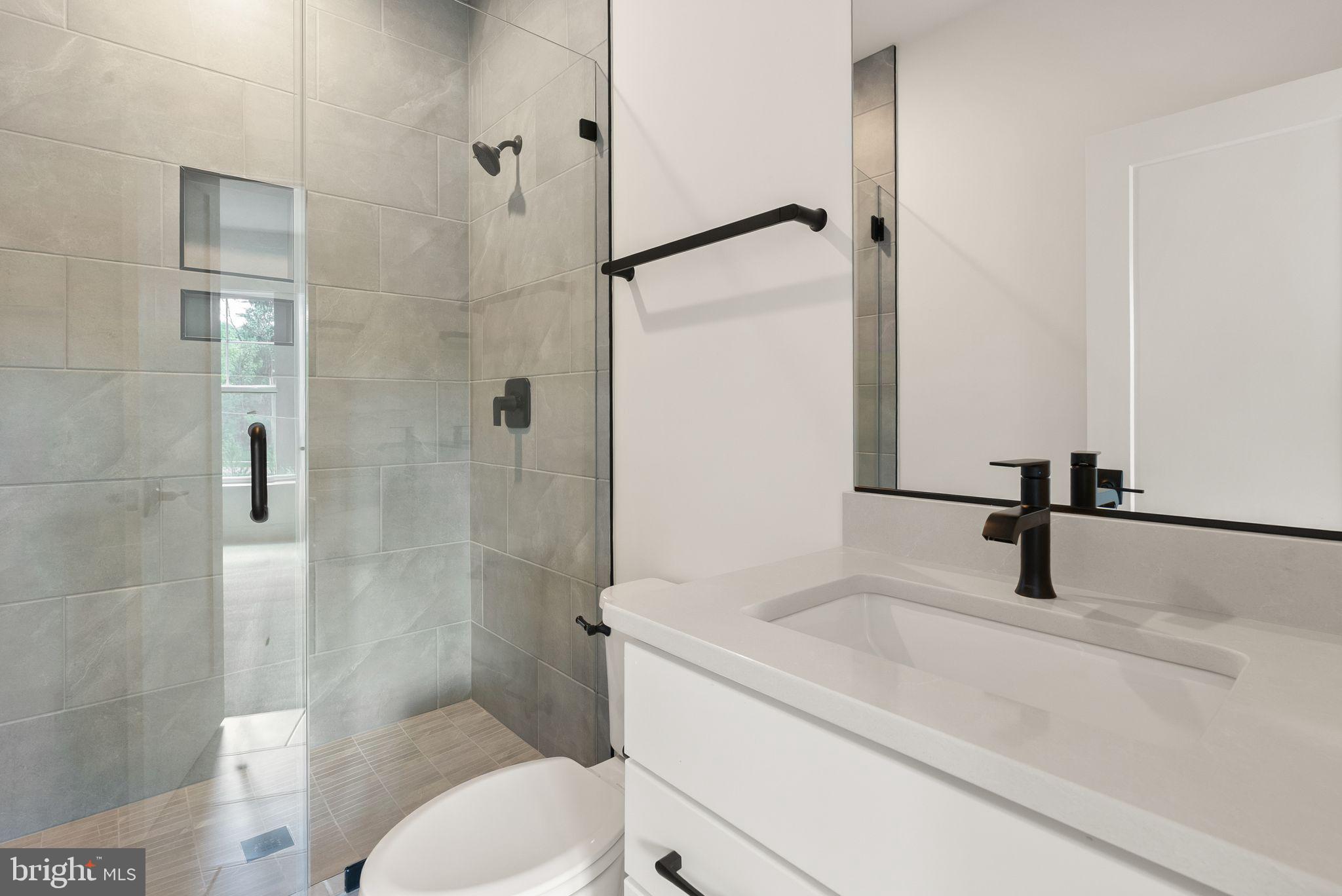 11800 Valley Road Fairfax, VA 22033 - Photo 54 of 76 a bathroom with a granite countertop sink toilet and shower