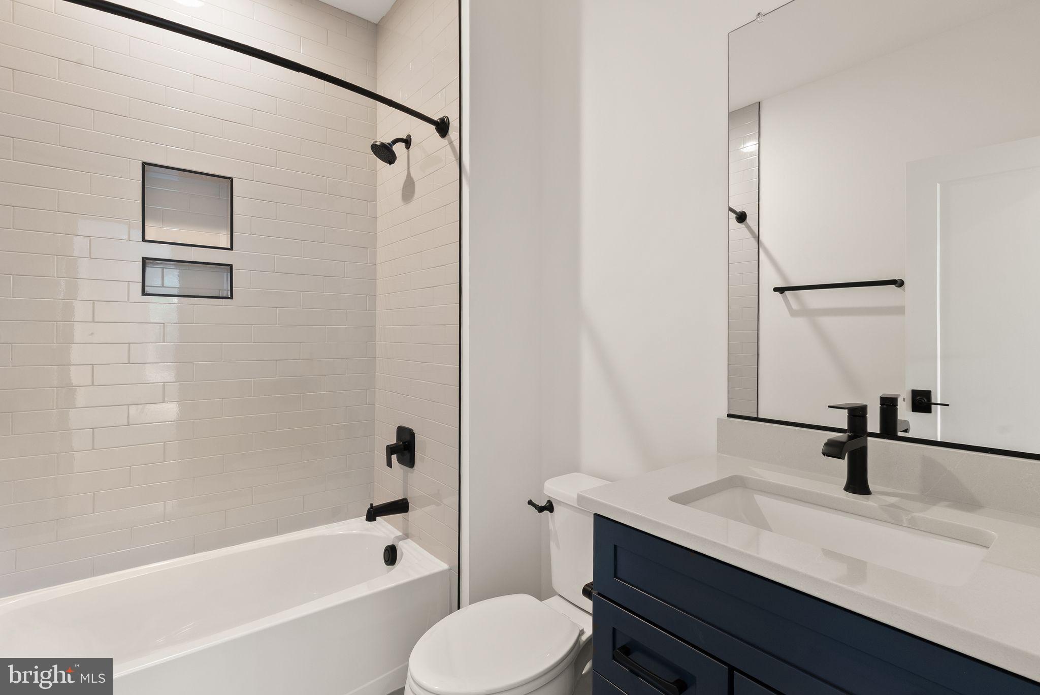 11800 Valley Road Fairfax, VA 22033 - Photo 58 of 76 a bathroom with a sink toilet a mirror and shower