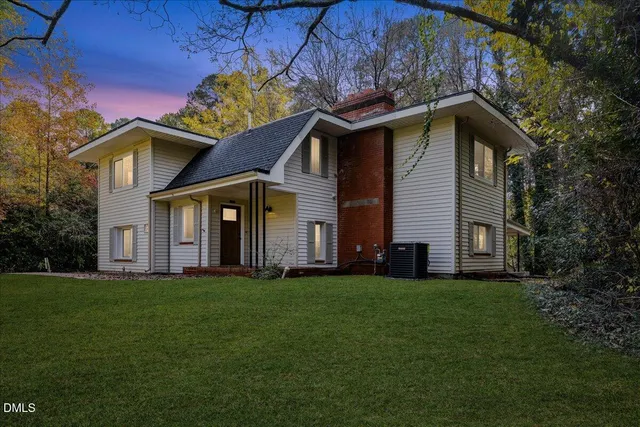 a front view of a house with a garden