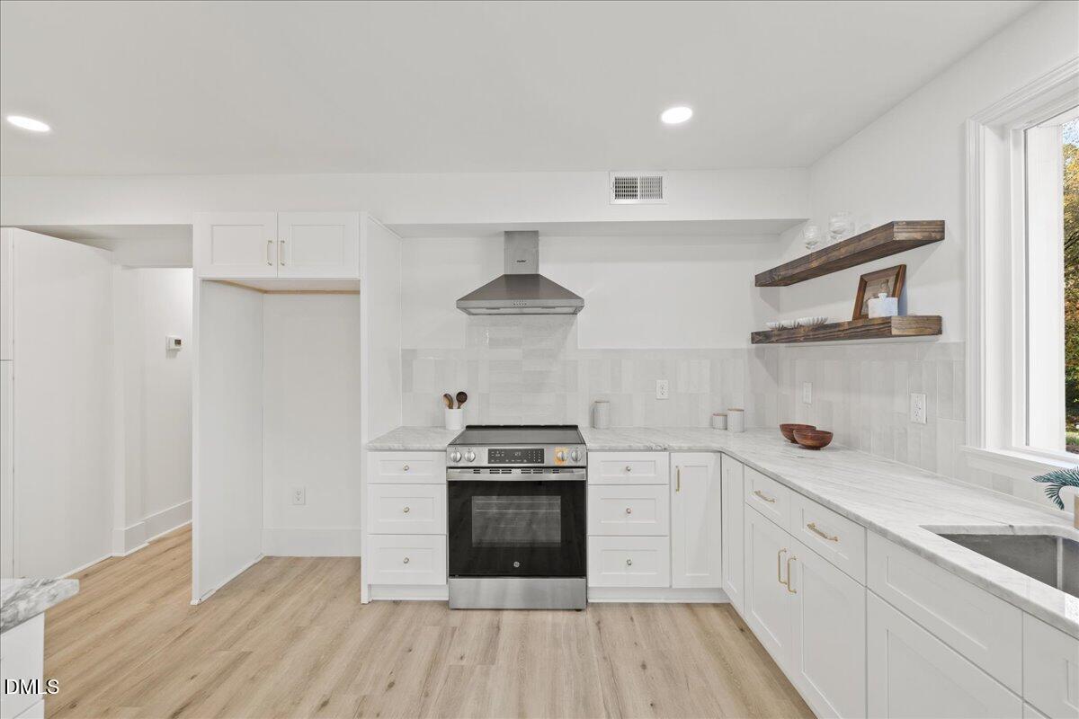 1615 Carbonton Road Sanford, NC 27330 - Photo 10 of 43 a kitchen with a stove and a refrigerator
