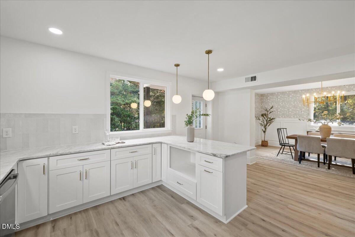 1615 Carbonton Road Sanford, NC 27330 - Photo 11 of 43 a large white kitchen with cabinets a sink a window and dining table