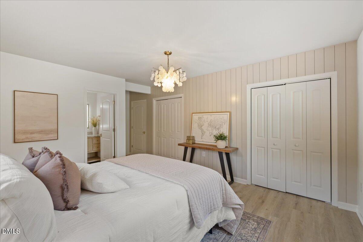 1615 Carbonton Road Sanford, NC 27330 - Photo 17 of 43 a bedroom with a bed and a chandelier