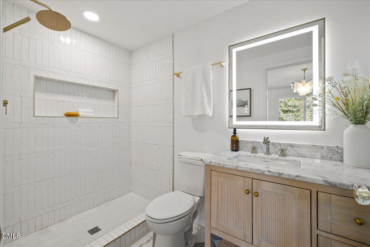 1615 Carbonton Road Sanford, NC 27330 - Photo 18 of 43 a bathroom with a granite countertop sink a toilet and a mirror