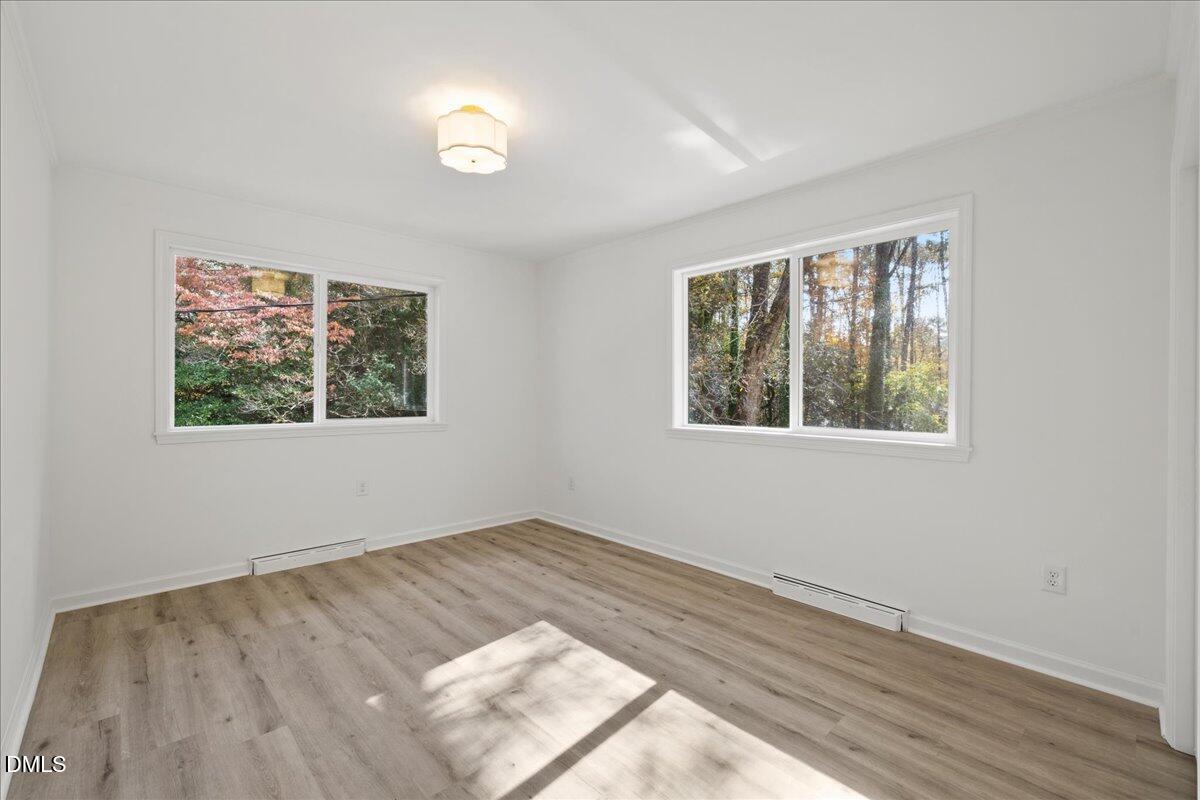 1615 Carbonton Road Sanford, NC 27330 - Photo 19 of 43 a view of an empty room with wooden floor and a window