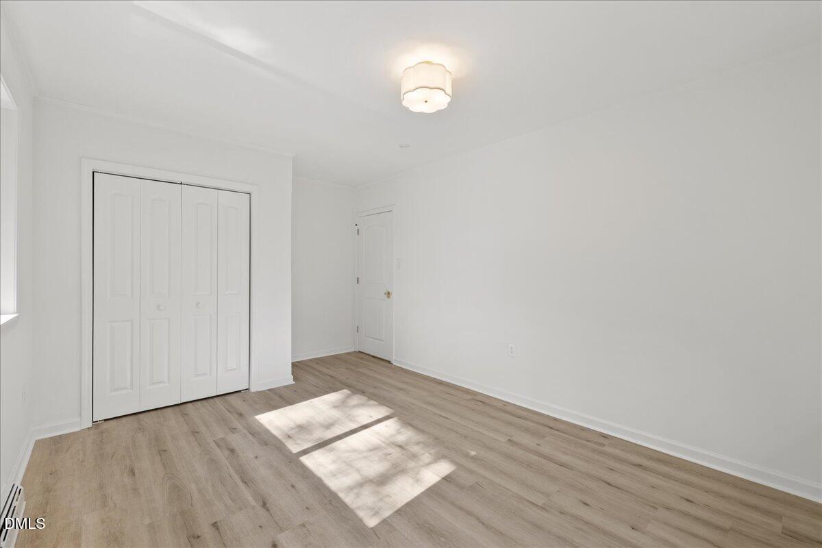 1615 Carbonton Road Sanford, NC 27330 - Photo 20 of 43 a view of empty room with wooden floor and fan