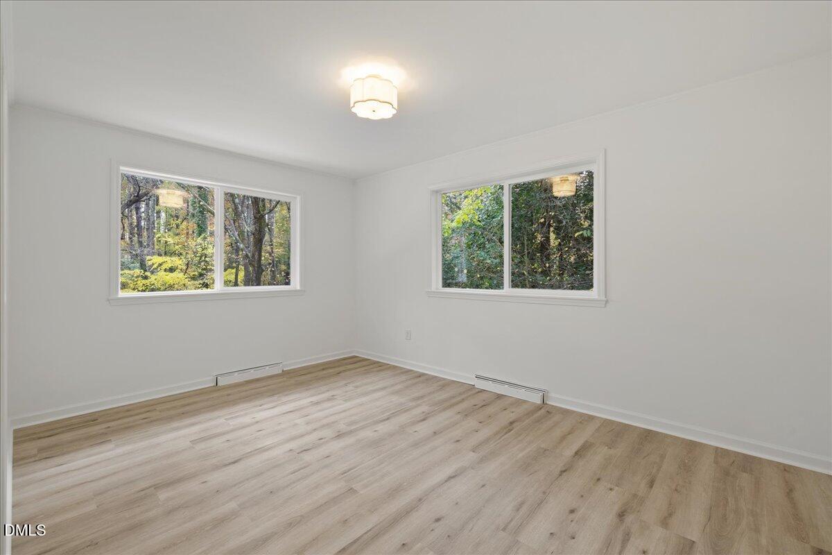 1615 Carbonton Road Sanford, NC 27330 - Photo 26 of 43 a view of an empty room with wooden floor and a window