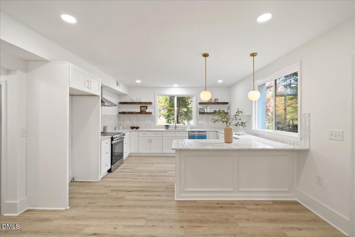 1615 Carbonton Road Sanford, NC 27330 - Photo 7 of 43 a large white kitchen with lots of counter space wooden floor and appliances