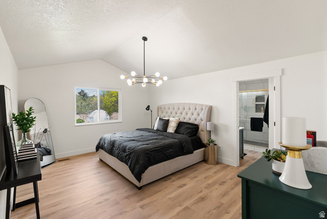 368 Spring Creek Road Providence, UT 84332 - Photo 9 of 45 Bedroom with light wood finished floors, a textured ceiling, ensuite bathroom, and hanging lights