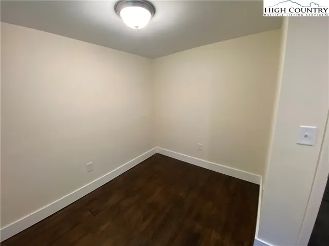 an empty room with wooden floor