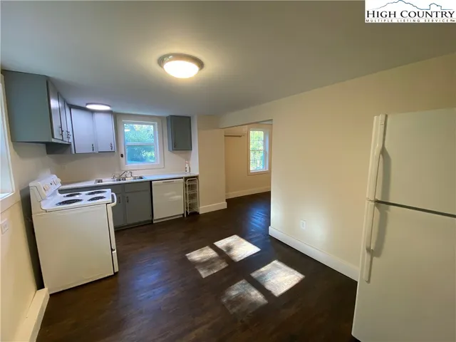 a kitchen with a sink appliances and cabinets