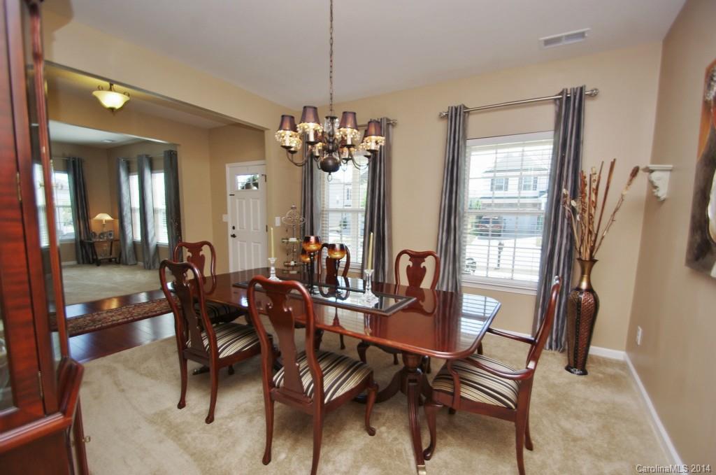 1601 Ridgehaven Road, Unit 245 Waxhaw, NC 28173 - Photo 3 of 24 a view of a dining room with furniture and a chandelier