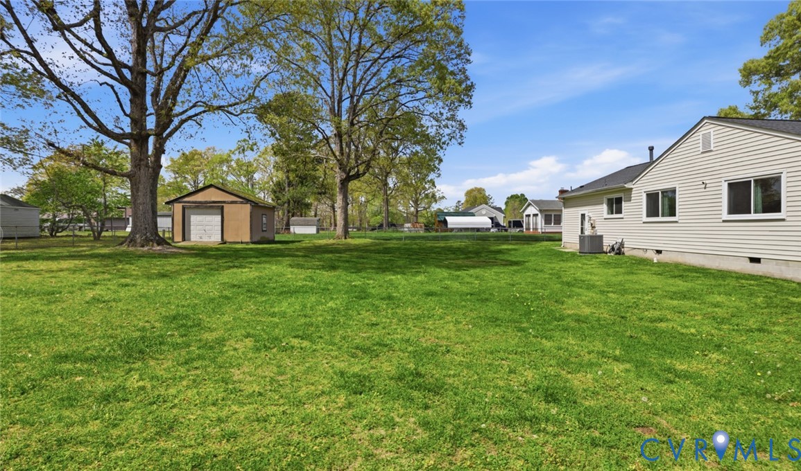 598 Old Wagner Road Petersburg, VA 23805 - Photo 36 of 43 Expansive green lawn with mature trees and a detac