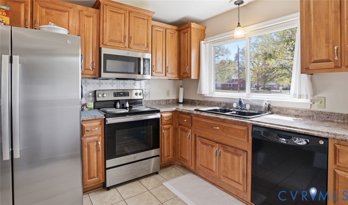 598 Old Wagner Road Petersburg, VA 23805 - Photo 9 of 43 Kitchen featuring wood-finish cabinetry, tile floo