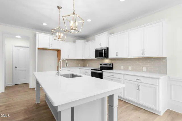 a kitchen with a sink stove and cabinets
