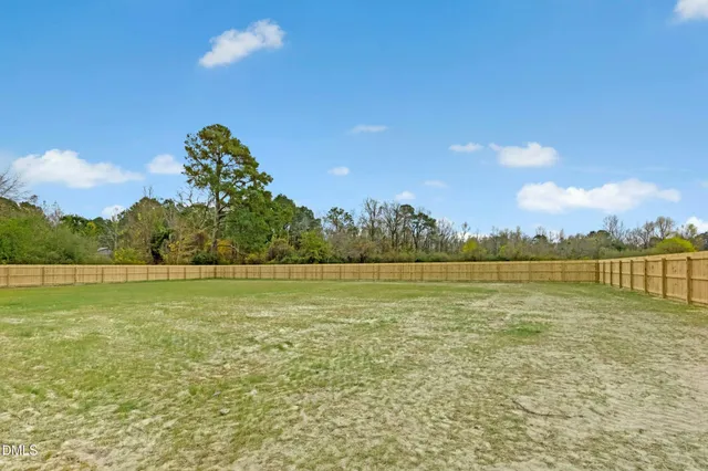 a view of a room with a ceiling fan and a ceiling fan