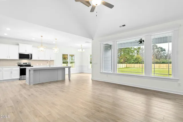 a view of an empty room with a fireplace and a window