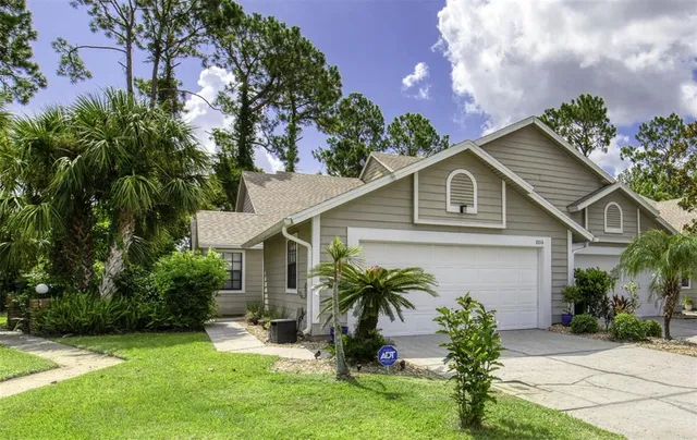 a front view of house with yard and green space