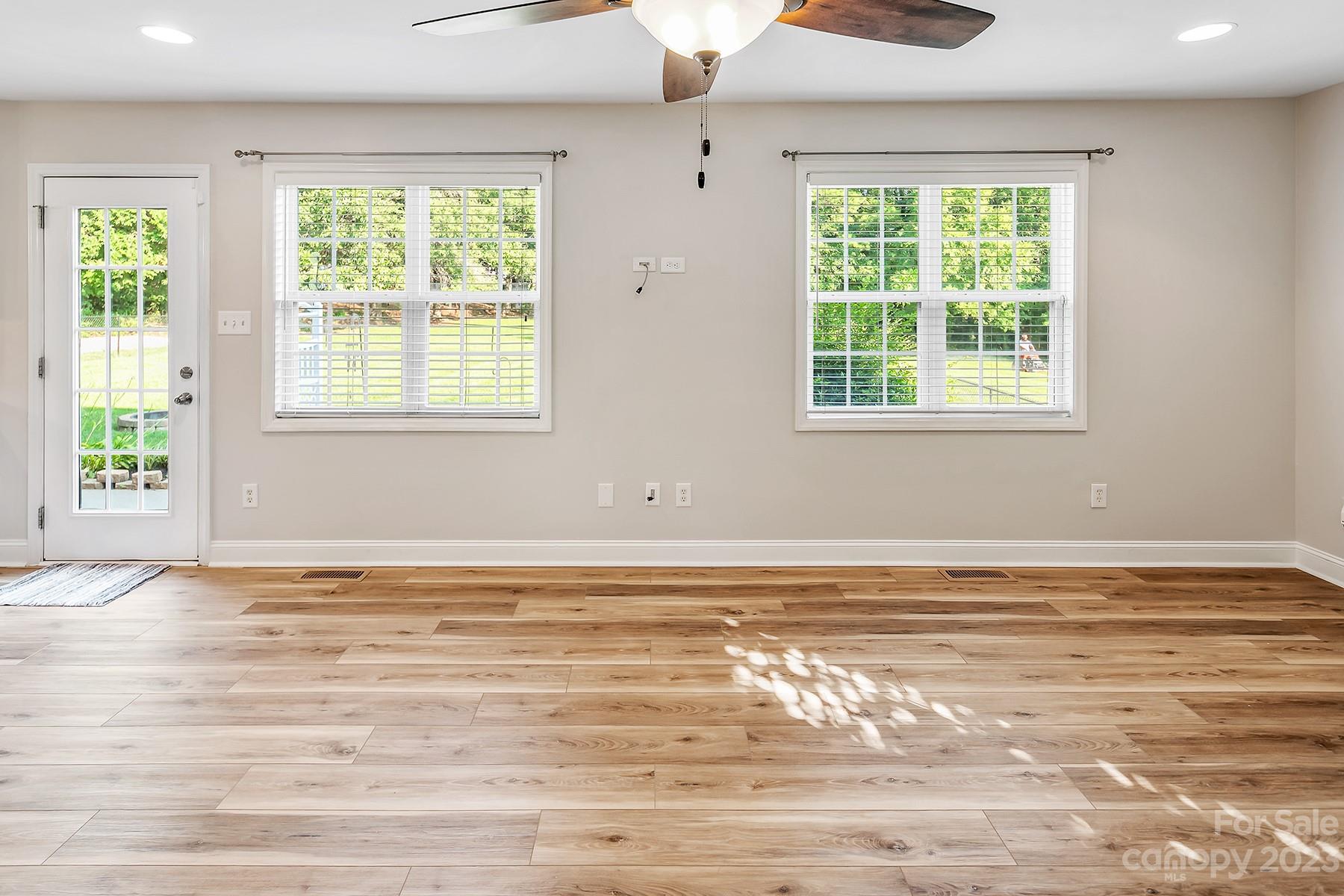 211 Todd Circle Wingate, NC 28174 - Photo 18 of 45 an empty room with wooden floor and windows