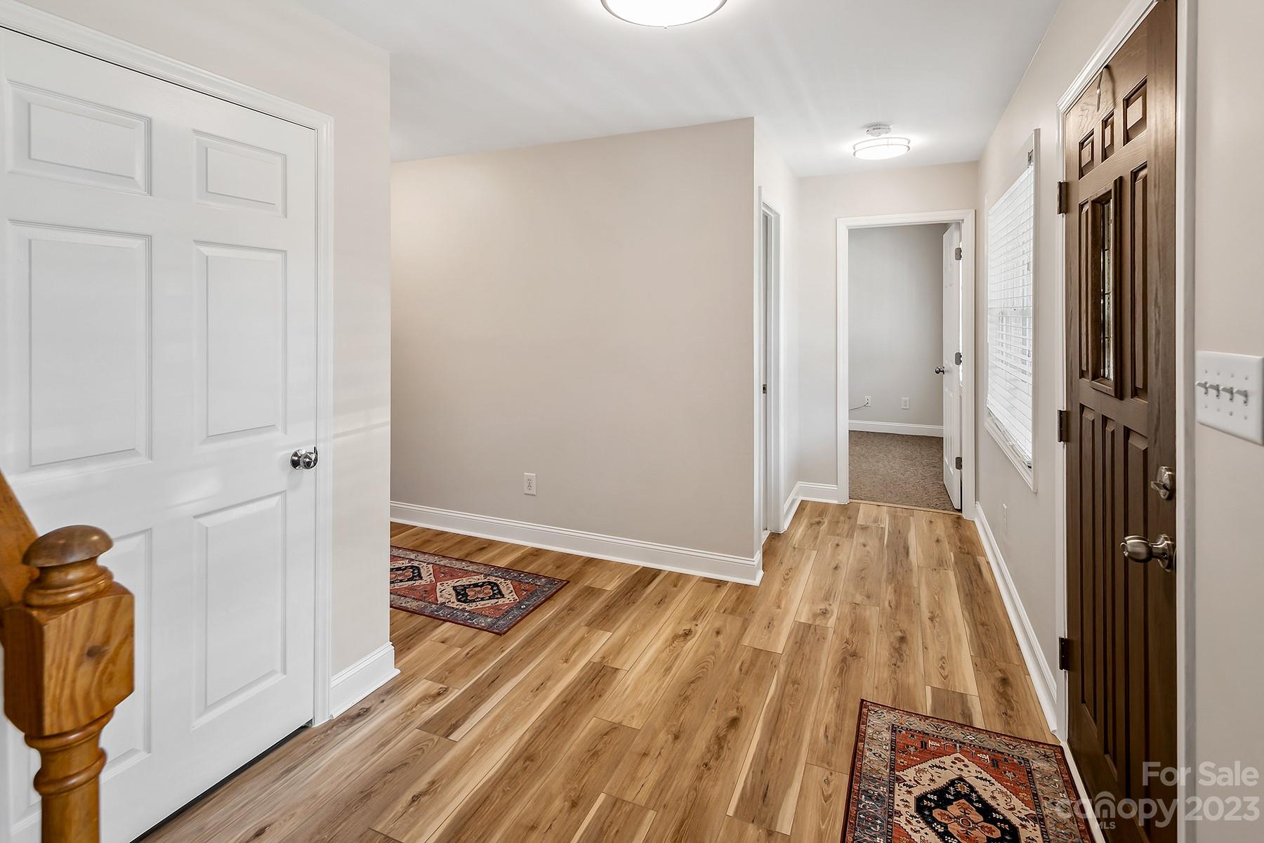 211 Todd Circle Wingate, NC 28174 - Photo 23 of 45 a view of a hallway with wooden floor and staircase