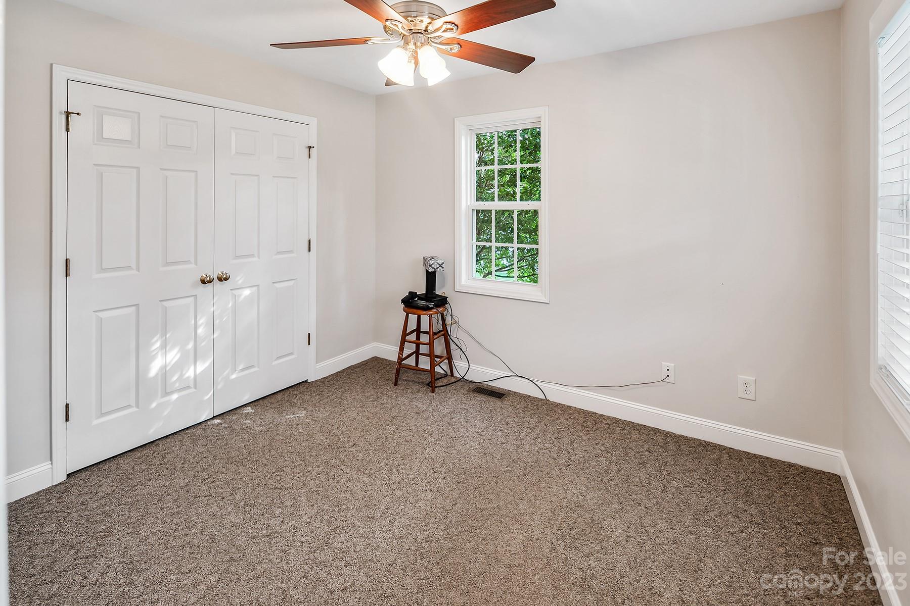 211 Todd Circle Wingate, NC 28174 - Photo 24 of 45 an empty room with windows and fan
