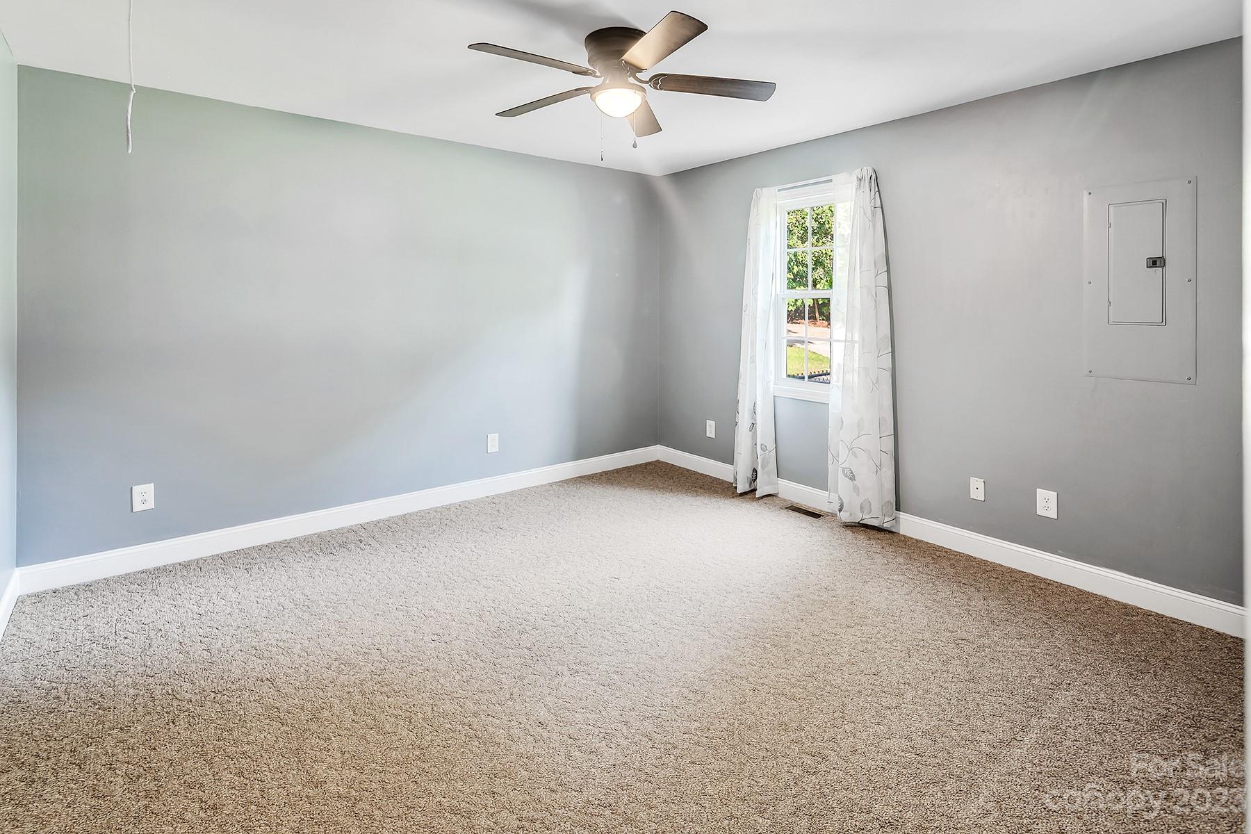 211 Todd Circle Wingate, NC 28174 - Photo 26 of 45 an empty room with windows and ceiling fan