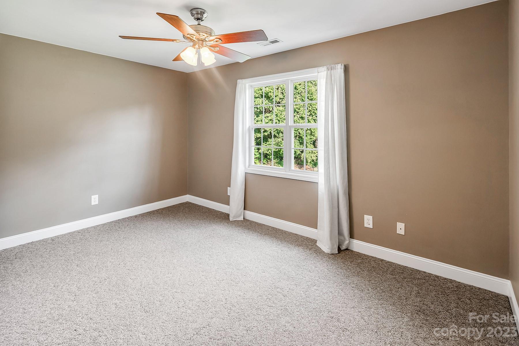 211 Todd Circle Wingate, NC 28174 - Photo 27 of 45 an empty room with a window and a fan