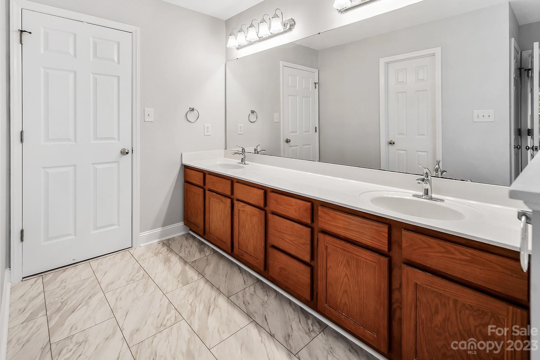 211 Todd Circle Wingate, NC 28174 - Photo 34 of 45 a spacious bathroom with a double vanity sink and a mirror