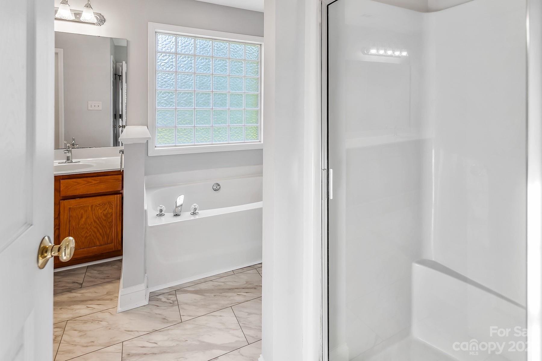 211 Todd Circle Wingate, NC 28174 - Photo 35 of 45 a bathroom with a tub and shower