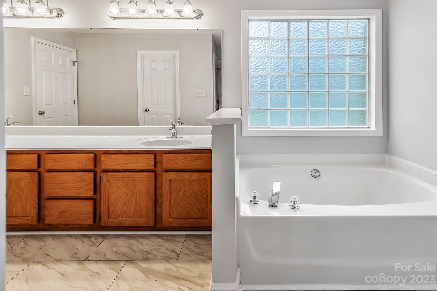 211 Todd Circle Wingate, NC 28174 - Photo 36 of 45 a bathroom with a bathtub and next to a window